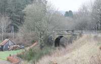 The A827 road from Aberfeldy still crosses the branch line trackbed at Grandtully on this narrow overbridge, controlled by traffic lights. The line closed in 1965, two months short of its centenary. View towards Ballinluig on 6 April 2014. <br><br>[Mark Bartlett 06/04/2014]