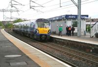 A crew change about to take place on the 09.48 Edinburgh - Helensburgh service during its stop at Airdrie on 8 May 2014. <br><br>[John Furnevel 08/05/2014]