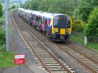 First TransPennine 350410 passing Curriehill on 27 May with a Manchester Airport - Edinburgh train.<br><br>[Bill Roberton 27/05/2014]