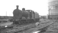 GNR(I) UG class 0-6-0 no 47 awaiting its fate in the sidings alongside Mayfields goods yard, Belfast, on 26 August 1965. Belfast gas works stands in the background. [Ref query 5455]<br>
 <br><br>[K A Gray 26/08/1965]