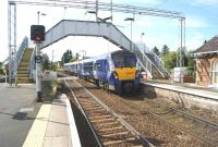 334029 runs over the level crossing as it arrives at Cardross with an eastbound service on 31 May 2014.<br><br>[John McIntyre 31/05/2014]