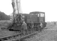 Contractors carrying out track lifting and recovery work between Kelso and Tweedmouth on 26 August 1969. NBL 0-4-0DH D2720 is in the process of being lifted onto the line near Kelso.<br><br>[Bruce McCartney 26/08/1969]