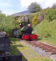 If only Cumbrian weather was always like this. <I>Sir Tom</I> makes light work of the gradient approaching the shed area at Threlkeld Quarry on 18 May. Notice the informal seating area to the left - an excellent place to eat lunch and watch the trains go by!<br><br>[Ken Strachan 18/05/2014]