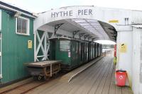 Hythe Pier Head, showing a train under the overall roof. The flat truck is used to carry bags and bulky items and behind that is the <I>Driving Trailer</I>, two further coaches (all with wooden slatted seats) and the electric loco. The pedestrian ramp to the Solent Ferry is just behind the camera. <br><br>[Mark Bartlett 25/05/2014]