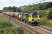 The <I>Scenic Settler</I> ran from Eastleigh to Carlisle on 21 June with Class 70 haulage over the S&C and Shap. The returning excursion is seen heading south at Woodacre behind Freightliner 70002 with DBS 66135 also in the train and a fine rake of <I>Blood and Custard</I> MkI coaches. <br><br>[Mark Bartlett 21/06/2014]