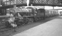 An otherwise quiet period at Carlisle station in August 1963 sees Upperby shed's Ivatt 2-6-0 no 46455 shunting a pair of TPO vans on the centre road.   <br><br>[K A Gray 03/08/1963]