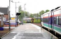 North and southbound ScotRail services meet at Larbert station in the pouring rain on 25 May 2005.<br><br>[John Furnevel 25/05/2005]