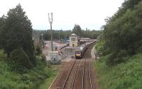 A northbound train heading through Gleneagles on 27 June, showing the new car park and station improvements made for the Ryder Cup golf tournament in September.<br><br>[John Robin 27/06/2014]