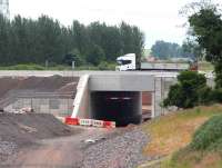 Almost back to normal at Sheriffhall on 27 June as a truck heads west over the new Borders Railway bridge towards Sheriffhall roundabout, with much of the abandoned diversionary route now removed. <br><br>[John Furnevel 27/06/2014]