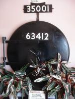 A smokebox door mocked up and purporting to be from Raven Q6 0-8-0 63412 adorns the wall of the entrance foyer of <I>The Sidings</I> Hotel and Restaurant adjacent to the ECML. The door displays a 52F Blyth shed plate, despite that loco being allocated to 51C West Hartlepool during its final years of service. The door, which is with hinges on the wrong side, appears to be from another class of loco, as the hinges do not match those in views of the class and there is not a pillar type protrusion on the centre line near the edge of the door on the opposite side to the hinges. <br><br>[David Pesterfield 29/06/2014]