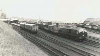 A DMU leaving Fraserburgh for Aberdeen on 18 August 1961, passing NBL Type 2 no D6156 (then less than a year old) standing in the yard with a freight. <br><br>[G H Robin collection by courtesy of the Mitchell Library, Glasgow 18/08/1961]