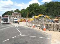The rerouted Stirling Street, Galashiels, on 30 June 2014 looking north over the site once occupied by the town's bus station [see image 46841]. Work is now underway on the new transport interchange. Arriving on the left is Perrymans bus service no 60, the 10.45 ex-Tweedmouth and Berwick.  <br><br>[John Furnevel 30/06/2014]