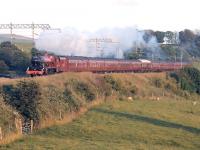 Just before the longest day of 2014 and there's plenty of evening sun to illuminate <I>Jubilee</I> 45699 <I>Galatea</I> and the returning <I>Fellsman</I> excursion as it passes Bay Horse near Lancaster.<br><br>[Mark Bartlett 18/06/2014]