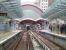 View south from a train entering West India Quay on the Docklands Light Railway on 26 May. Directly ahead (and very close) is Canary Wharf station with a DLR train to Stratford in the centre road.<br><br>[John Thorn 26/05/2014]