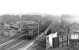 A northbound Cravens DMU crossing Battlefield Road on the approach to Mount Florida in the early 1960s. The building on the right is the former Langside tram depot, opened in 1901 and converted to a bus garage from 1957. Operations ceased here in 1984 and housing now occupies the site.<br><br>[David Stewart //]