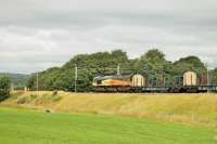 The <I>log empties</I> from Chirk to Carlisle usually run overnight but on Sundays there is a day time train. Colas Rail 66847 is seen here heading north on 13 July with the bare looking wagons, between Brock and Garstang.<br><br>[Mark Bartlett 13/07/2014]