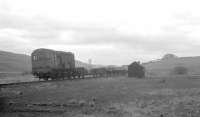 A diesel shunter on its way down from Stobs to Hawick with a recovery train in early 1970 with wagons carrying rail chairs and scrap iron.<br><br>[Bruce McCartney //1970]