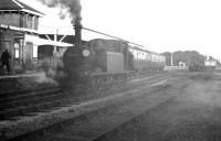 A smokescreen descends over Hayling Island station on 30 October 1962 as LBSCR <I>Terrier</I> 0-6-0T no 32650 runs round the branch train from Havant. The 1876 veteran (which hauled the last scheduled BR service over the branch on 3 November 1963) survives in preservation. <br><br>[K A Gray 30/10/1962]