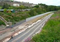 The northern approach to Galashiels seen from Kilnknowe Place road bridge on 29 July 2014. The houses of Wood Street stand up on the left with the A72 running in parallel just beyond. View towards the point where the Peebles Loop and Waverley route began to diverge. [See image 28518] <br><br>[John Furnevel 29/07/2014]