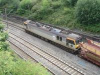 GBRF operated 92043 <I>Debussy</I>, with Eurotunnel markings, emerges from the tunnel under the former 5A Crewe North shed on 29 July with a long rake of STVA empty double deck car carrier wagons.<br><br>[David Pesterfield 29/07/2013]