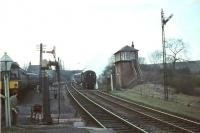 The signalman at Busby prepares to collect the tablet from a standard tank bringing down a train of empty stock from East Kilbride in April 1966.  <br><br>[John Robin /04/1966]