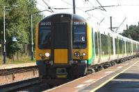 Clocking up the miles, London Midland 350374 helping out during the Commonwealth Games, strengthening the 1S71 Manchester Airport to Glasgow TPE service with a 350/4 on the rear. The train rushes north through Leyland on 2 August 2014.<br><br>[John McIntyre 02/08/2014]