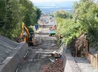 View south along the Waverley trackbed from the A6094 road bridge at Eskbank on 3 August 2014 [see image 48252] with the new Eskbank station and footbridge under construction in the background. <br><br>[John Furnevel 03/08/2014]