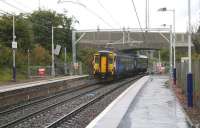 156510 leaves the fully wired Bargeddie station on 21 August 2014 and passes under the completed A752 road bridge heading toward Whifflet. [See image 47157]<br><br>[Colin McDonald 21/08/2014]