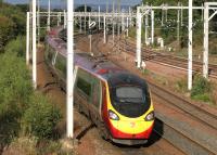 The 1840 Pendolino from Glasgow Central passes Newton West Junction at speed on a Bank Holiday Monday in August 2014. Engineering works at Watford mean the service will terminate at Milton Keynes on this occasion.<br><br>[Colin McDonald 25/08/2014]