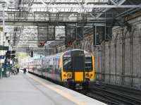 TransPennine 350410 draws to a halt beyond the crossover separating platforms 11 and 7 at Edinburgh Waverley on 22 August 2014. The train is the terminating 10.00 ex-Manchester Aiport.<br><br>[John Furnevel 22/08/2014]