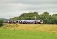 A pair of TransPennine Express EMUs, 350403/408, running through the Lancashire countryside between Garstang and Brock on 13 July 2014 with a Sunday Edinburgh to Manchester Airport service.<br><br>[Mark Bartlett 13/07/2014]