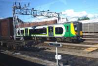 View from a passing train as a London Midland service departs from Crewe on 23 August 2014, about to run past an interesting item of equipment in the foreground(?).<br><br>[John Steven 23/08/2014]