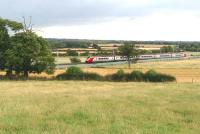 A Virgin Voyager forming the 1510 London Euston - Chester speeds through the Northamptonshire countryside near Bugbrooke on 21 August heading for its penultimate stop at Crewe.<br><br>[John Steven 21/08/2014]