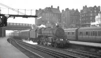 BR Standard class 5 4-6-0 no 73075 runs into the north end of Carlisle on 3 August 1963 with the summer Saturday 1.57pm Gourock - Birmingham New Street. The Polmadie locomotive will hand over to a Holbeck <I>Jubilee</I> for the next leg of the journey south as far as Leeds [see image 47420].<br><br>[K A Gray 03/08/1963]