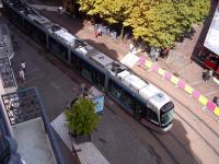 Hotel balcony view of Grenoble Alstom Citadis Tram 6025 of the TAG fleet, on a Line B service, negotiating the tramworks in Place Grenette on 5 July 2014.<br><br>[Andrew Wilson 05/07/2014]