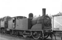 Ex-Caley 0-4-4T 55203 in the sidings alongside Corkerhill shed, thought to be in 1961. Stabled just beyond is BR standard 2-6-4 tank 80049. <br><br>[David Stewart //1961]