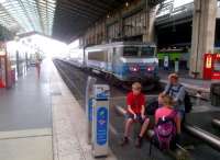 In the absence of benches, family accommodation may be found on the buffer stops. Gare du Nord on 5 August 2014. The locomotive is 115062, the train is the 14.07 to Saint-Quentin. [see image 15463]<br><br>[Ken Strachan 05/08/2014]