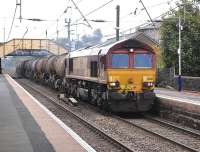 DBS 66130 passes through Glengarnock station on 29 September 2014 with the Mossend (ex Antwerp) china clay tanks to Caledonia Paper, Irvine.<br><br>[Bill Roberton 29/09/2014]