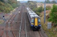 380107 passes the remains of Glengarnock yard with the 1131 Glasgow Central - Ayr on 29 September 2014. The loop here has been disconnected.<br><br>[Bill Roberton 29/09/2014]