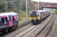 Trans Pennine EMUs meet at speed near Hest Bank on 30th September. 350409, on the left, is bound for Manchester Airport while 350405 is heading north on a service for Glasgow Central. <br><br>[Mark Bartlett 30/09/2014]