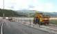 A road-rail vehicle parked on the realigned track alongside the newly widened road leading to the rebuilt Pont Briwet on 6th July 2014. The line from Harlech to Pwllheli is due to reopen by September 2014.<br><br>[Colin McDonald 06/07/2014]