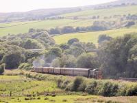 At various times during the ELR <I>Class 14s @ 50</I> gala a <I>Parcels</I> train was run on the Bury-Rawtenstall section. In addition to a mixed selection of parcel vans a couple of passenger coaches were in the consist. With the slopes of Holcombe Moor in the background, D9537 is seen powering through Irwell Vale heading back to Bury on the last Parcels of the day with D9539 bringing up the rear. Above the leading locomotive, Lumb viaduct on the long closed Stubbins-Accrington line is just visible, with scaffolding in place for repair work<br><br>[Mark Bartlett 26/07/2014]