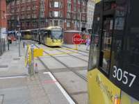 Single line Metrolink working through Manchester Victoria continued in August 2014 although the staff was being carried through the section by drivers rather than a pilotman. 3057 waits at Shudehill for a four car set to bring the staff through and the barrier across the tracks to be opened. <br><br>[Mark Bartlett 07/08/2014]