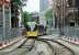 Metrolink 3060 leads a four car tram off the temporary single line section through Victoria and climbs towards Shudehill. This is now the only stop in the district while Victoria is closed to trams and so the pavements behind the <I>Heras</I> fencing are busy with commuters who wouldn't normally alight here.  <br><br>[Mark Bartlett 07/08/2014]