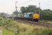 A longer train than usual for the Crewe-Sellafield flask working on 12 September, with six wagons behind DRS 37605 and 37610, seen here heading north through long closed Bay Horse station. The fourth wagon appeared to be new or recently <I>shopped</I> and was painted blue rather than brown like the others in the rake. <br><br>[Mark Bartlett 12/09/2014]