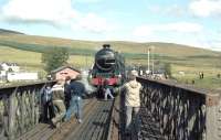 On Saturday 25 September 1982 the Scottish Steam Railtours Group <I>Raven's Rock Express</I> ran from Inverness to Kyle of Lochalsh. The special was advertised as <I>'The first public steam-hauled run to Kyle after an absence of 20 years'</I>. 5025 is seen here on the bridge over the River Bran at Achnasheen, where it paused to take on water. 37184 hauled the special on the return journey to Inverness.<br><br>[John Robin 25/09/1982]