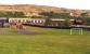 A plastic dragon and a collection of slag heaps - we could, perhaps, be West of the Severn. 'Mechanical Navvies Limited' prepares to take the 3pm down train away from Whistle Inn halt in August 2014. There is a tramway tunnel under the hill in the background.<br><br>[Ken Strachan 24/08/2014]