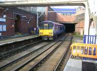 The 1104 Motherwell - Milngavie Argyle Line service leaves Bridgeton on Sunday morning 12 October 2014 and disappears into the 460 yard Canning Street Tunnel towards Glasgow Green.<br><br>[Veronica Clibbery 12/10/2014]