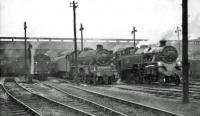 Part of the shed yard at Polmadie on Saturday 13 June 1964. Jubilee no 45742 <I>Connaught</I>, a visitor from Carlisle Kingmoor, stands alongside home based standard tank 80086.    <br><br>[John Robin 13/06/1964]