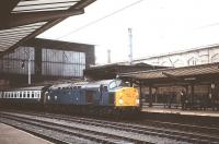 EE Type 4 40012 (formerly D212) at Carlisle with an up WCML train in August 1979. Withdrawn from main line service by BR in February 1985 the locomotive was reinstated 3 months later as departmental 97407 for use on the Crewe area remodelling project. After final withdrawal in April 1986 the loco was purchased for preservation in 1988. [See image 23791].<br><br>[Peter Todd /08/1979]